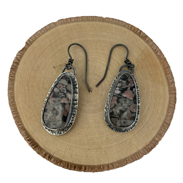 Unique earrings featuring crinoid fossil cabochons set in oxidized fine and sterling silver
