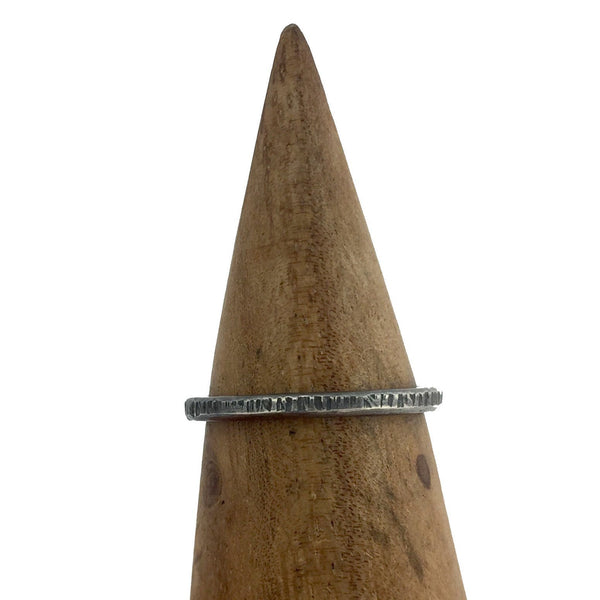 Close up of oxidized stacking ring with lines texture