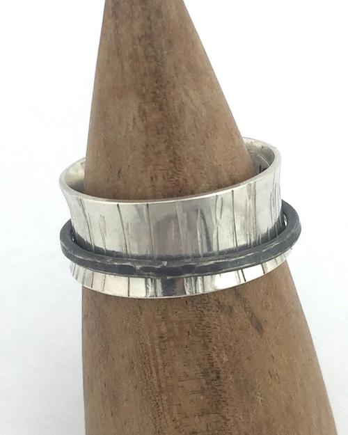 Close up of spinner ring with birch texture